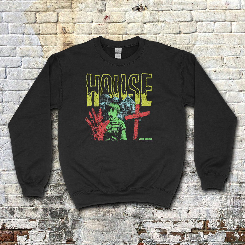 House sweatshirt featuring bold distressed yellow lettering, eerie green child, red handprint, cross, and haunted house graphic on black fabric