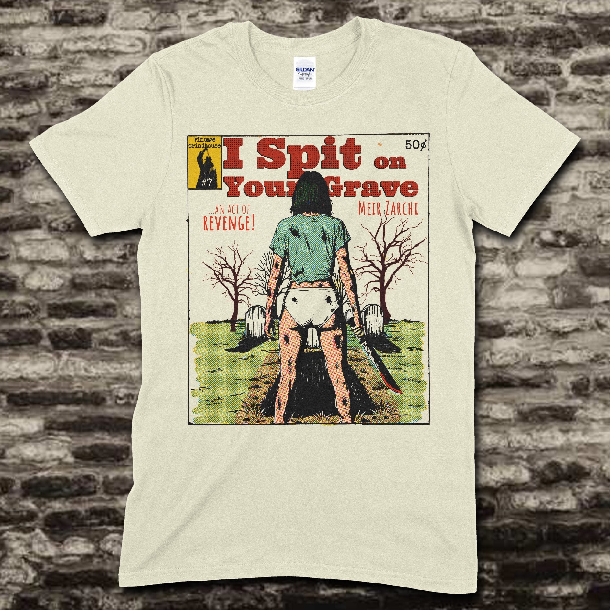Beige t-shirt featuring a vintage pulp comic style graphic of a woman holding a bloody knife with I Spit on Your Grave text on front