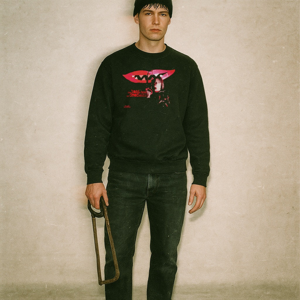 Black Last House on Dead End Street sweatshirt with red lips and vintage horror scene worn by man holding saw frame