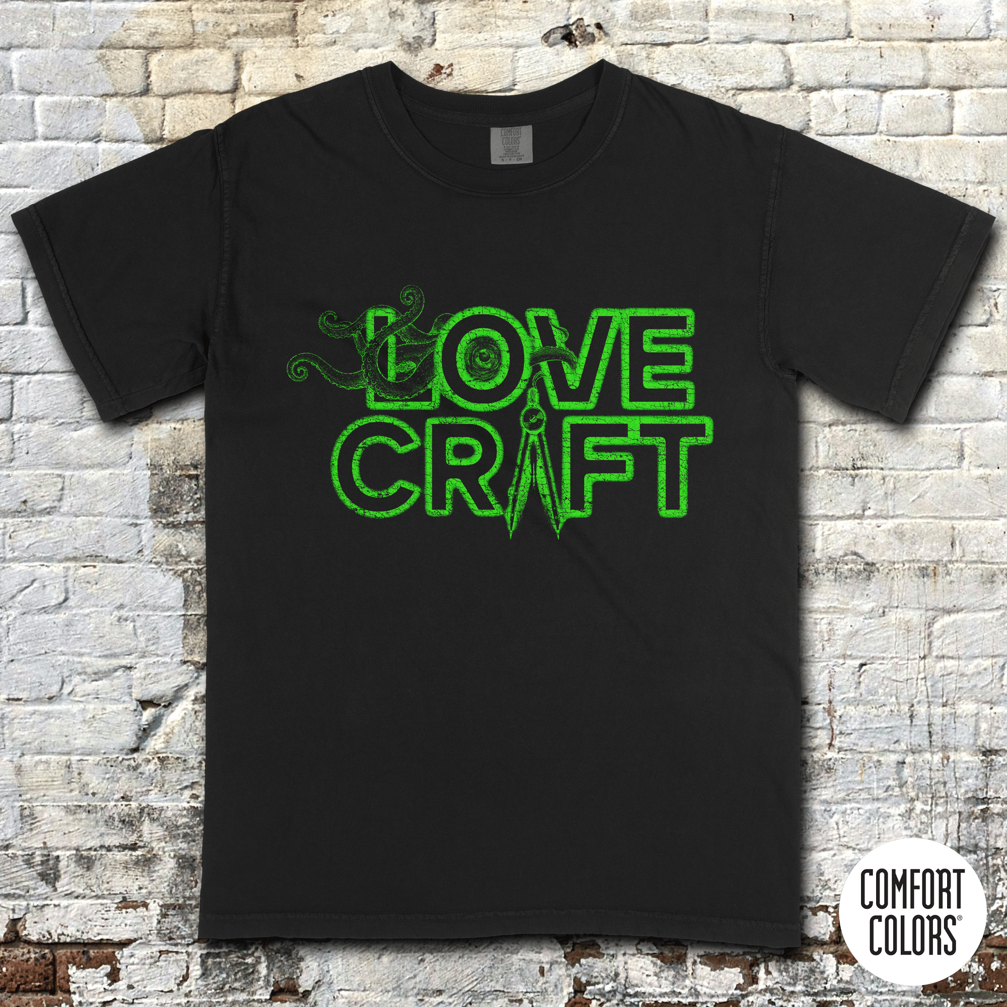 H.P. Lovecraft t-shirt with neon green text and tentacle graphic in retro style on black fabric background