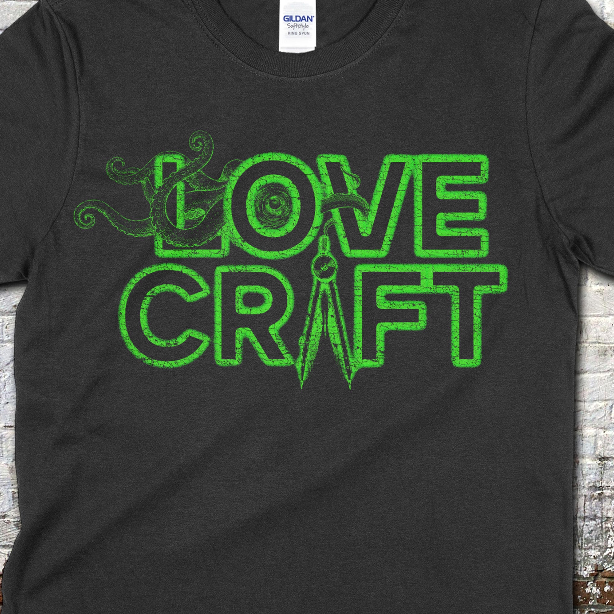 H.P. Lovecraft t-shirt in black with glowing green text featuring tentacles and an eye integrated into the design