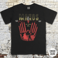 Manos - The Hands of Fate t-shirt featuring a vintage horror design with red hands and a man in black and yellow text