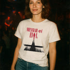 Woman wearing white t-shirt with retro horror-themed graphic and bold red text reading Messiah of Evil - Blood Moon Edition