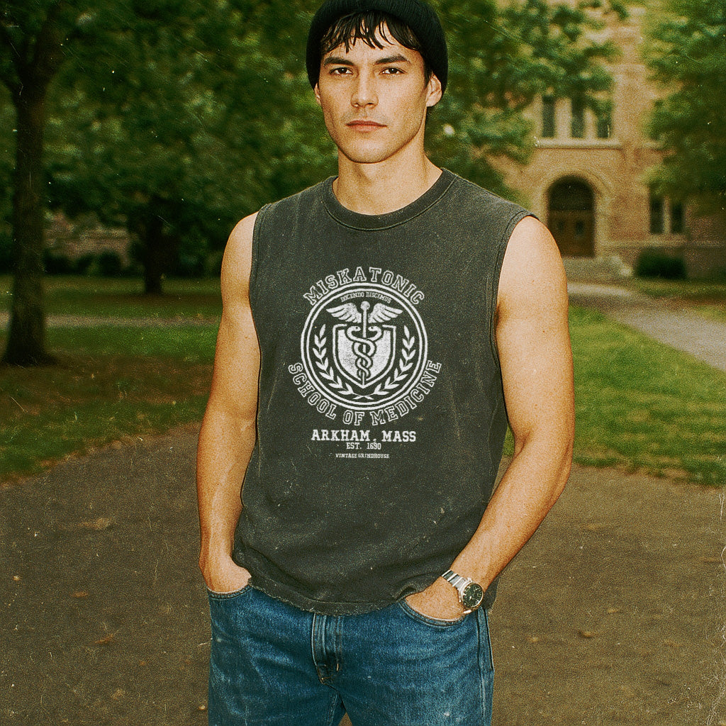 Miskatonic School of Medicine muscle tank featuring vintage medical emblem and text on faded dark fabric worn outdoors