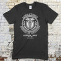 Black t-shirt featuring a vintage medical crest graphic with Miskatonic School of Medicine and Arkham, Mass text on front