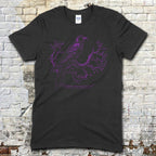 The Raven - "Nevermore" t-shirt features a purple crow perched on twisted branches with gothic script on black fabric.