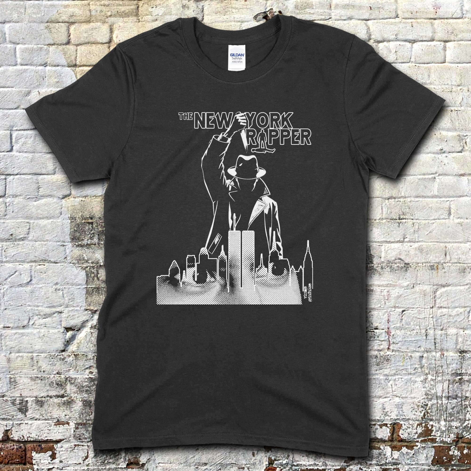 Black t-shirt featuring a noir-style figure above a city skyline with "The New York Ripper" text design