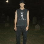 Night of the Living Dead design #1 muscle tank worn by model in graveyard under moonlight with eerie black and gray graphic