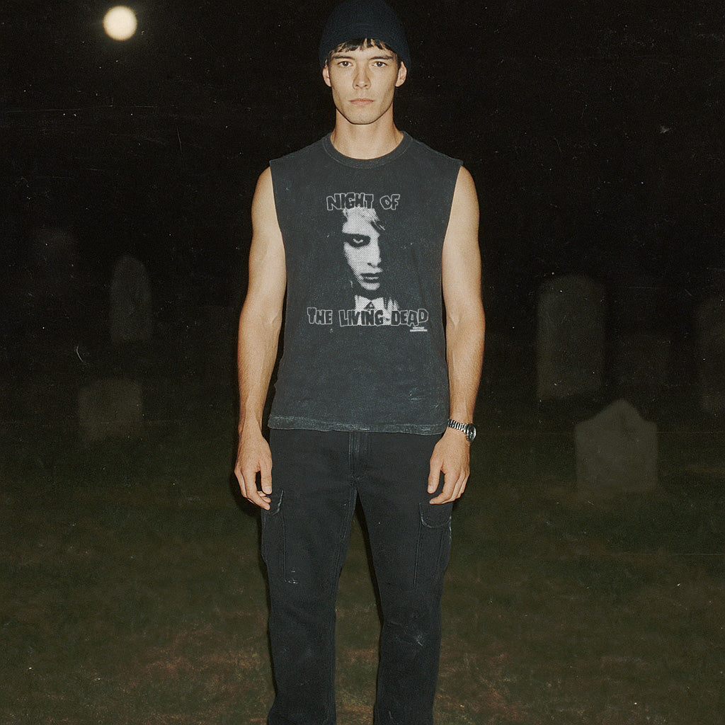 Night of the Living Dead design #1 muscle tank worn by model in graveyard under moonlight with eerie black and gray graphic