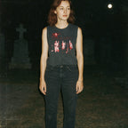 Night of the Living Dead design #2 muscle tank showing zombie figures in eerie red tones on dark fabric worn outdoors at night