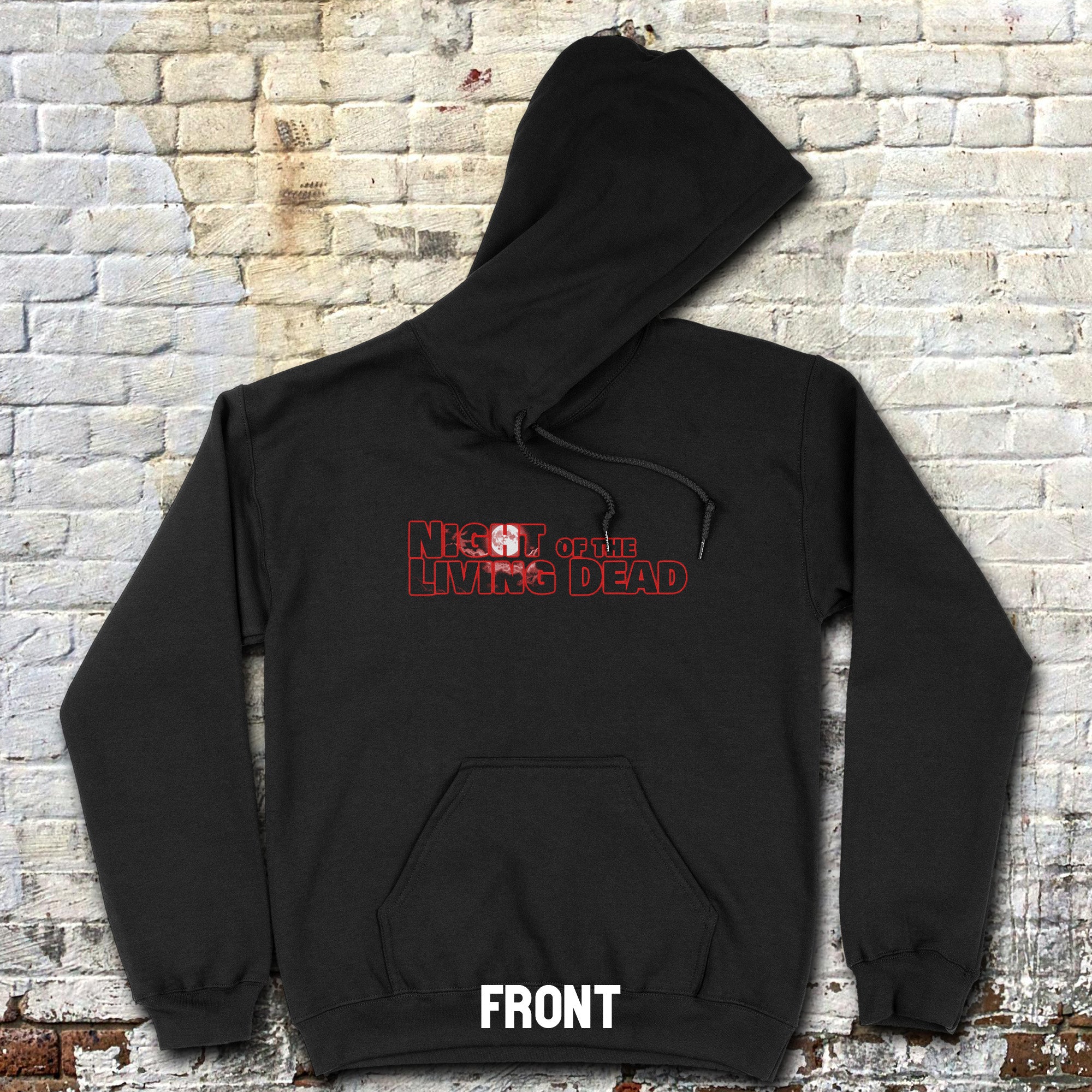 Black hoodie with 'Night of the Living Dead' text on a brick wall background