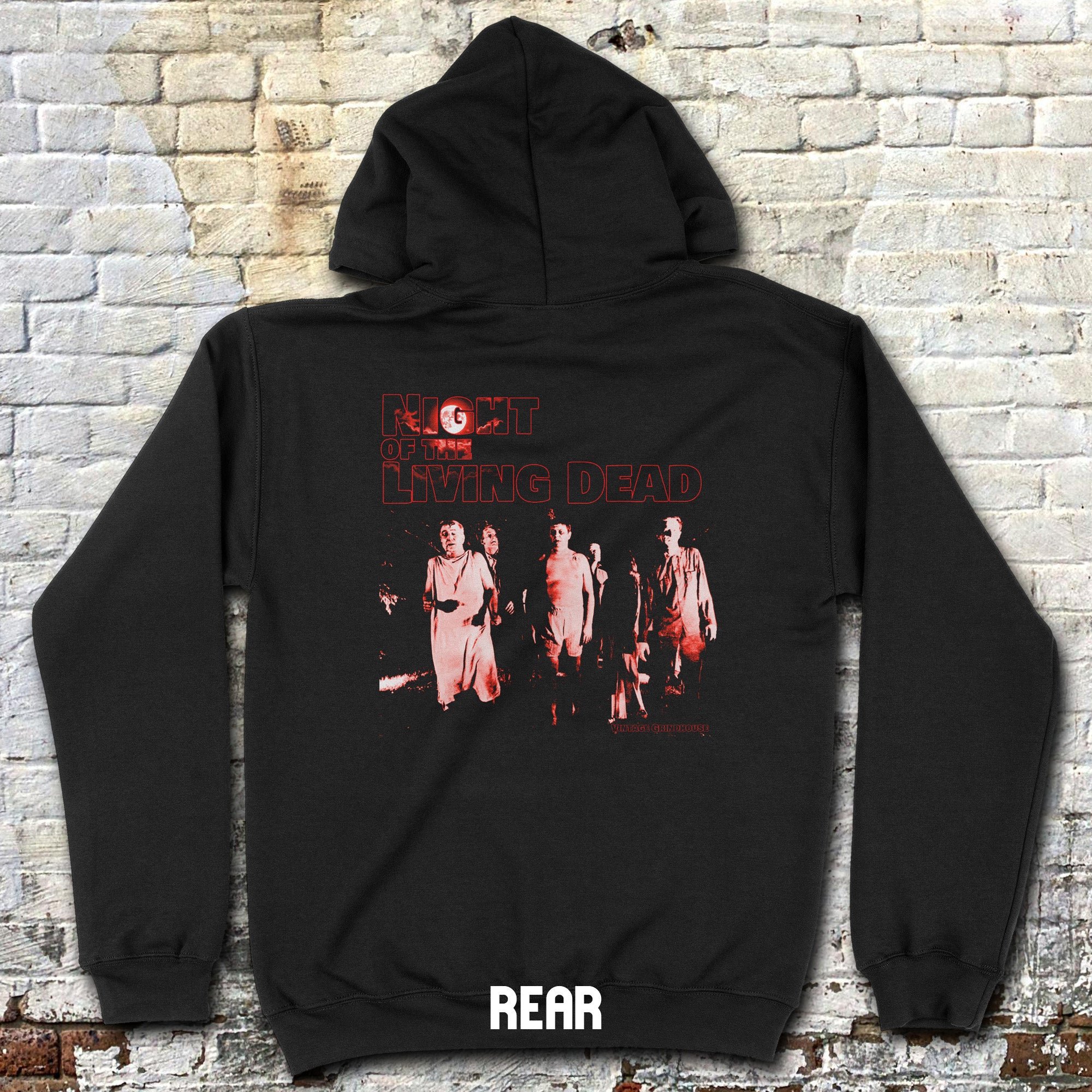 Black hoodie with 'The Walking Dead' graphic on a brick wall background