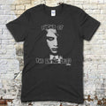 Black t-shirt featuring a stylized monochrome graphic of a zombie face with Night of the Living Dead text on front