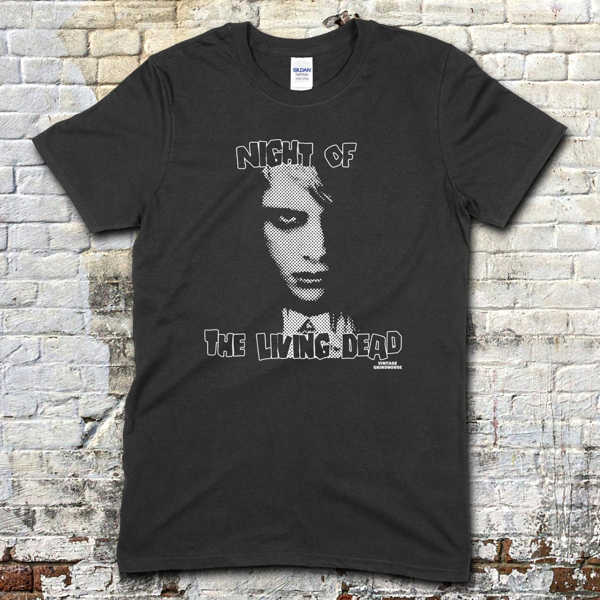 Black t-shirt featuring a stylized monochrome graphic of a zombie face with Night of the Living Dead text on front