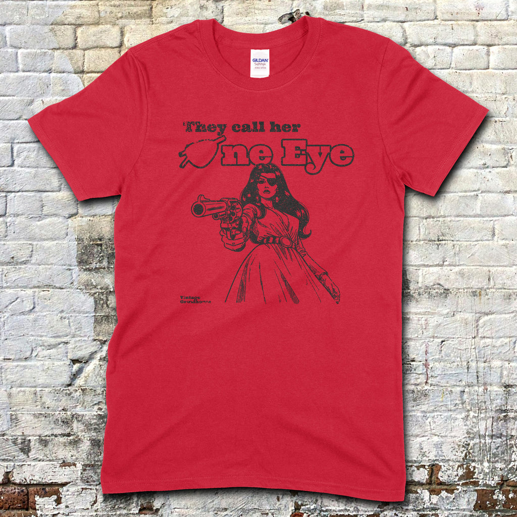 Red t-shirt featuring a black graphic of a woman pointing a gun with They call her One Eye text on front