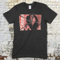 Black t-shirt featuring a torn vintage horror movie poster graphic of a man and woman with blood red text on front