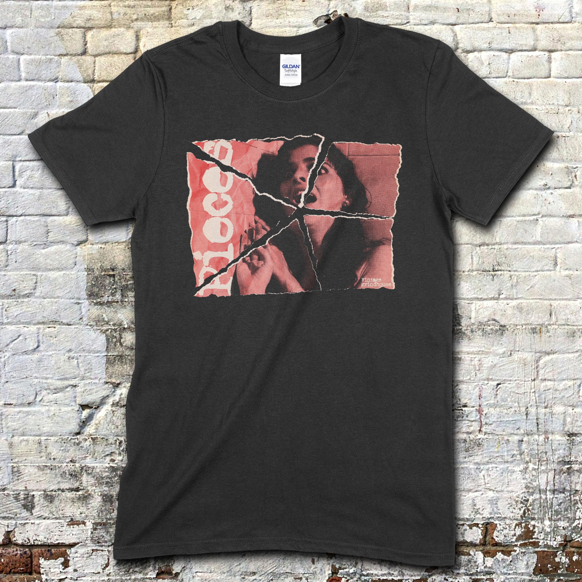 Black t-shirt featuring a torn vintage horror movie poster graphic of a man and woman with blood red text on front