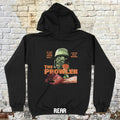 Black hoodie with graphic design on the back against a brick wall background