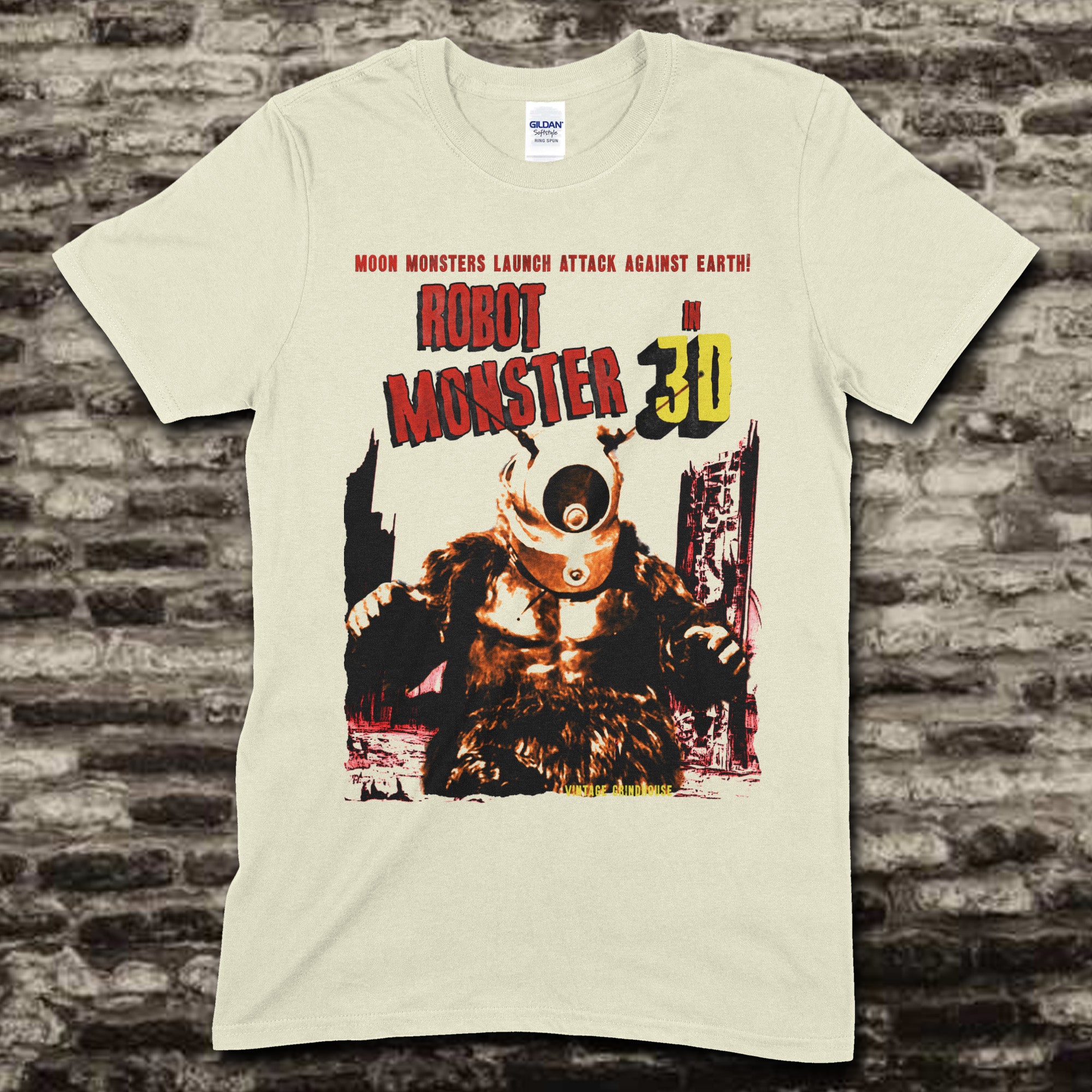 Beige t-shirt featuring a vintage sci-fi graphic of Robot Monster with text Moon Monsters Launch Attack Against Earth on front