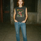 Woman wearing Santa Claus Conquers the Martians muscle tank with vintage Santa and alien combat illustration