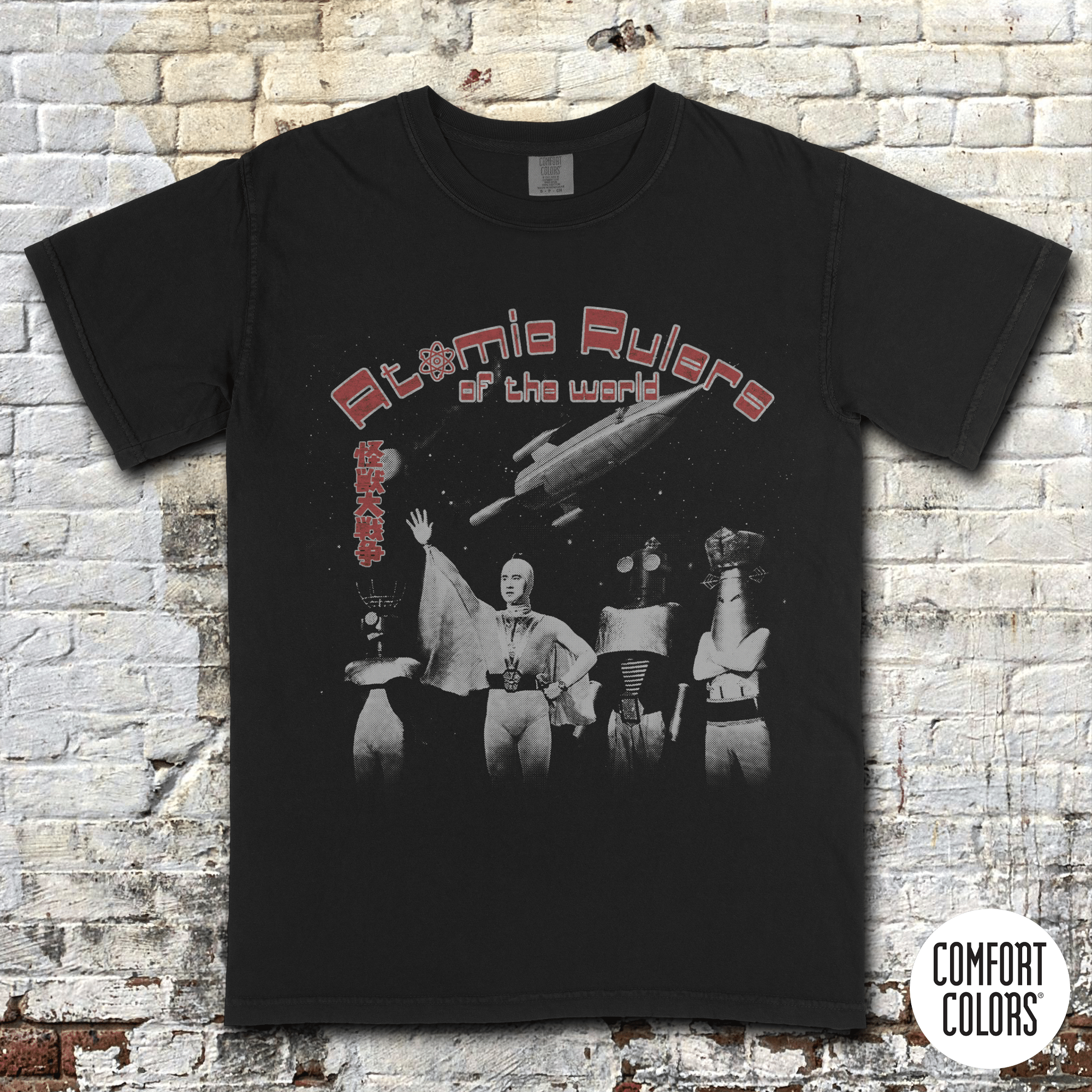 Atomic Rulers of the World t-shirt featuring vintage sci-fi characters and a spaceship in retro grindhouse style design.