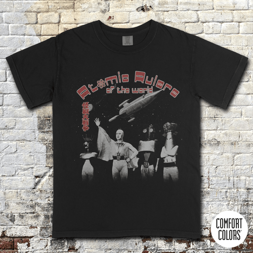 Atomic Rulers of the World t-shirt featuring vintage sci-fi characters and a spaceship in retro grindhouse style design.