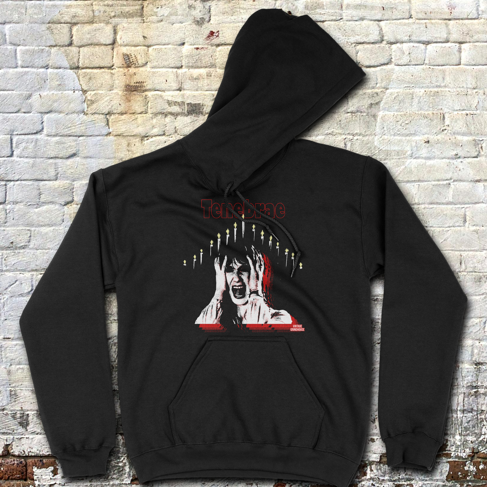Tenebrae hoodie featuring a screaming woman surrounded by lit candles with distressed red and white horror text design on black fabric
