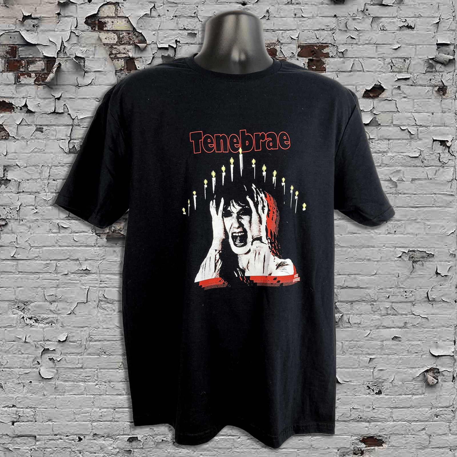 Black t-shirt with graphic design and 'Tenebrae' text on a textured wall background