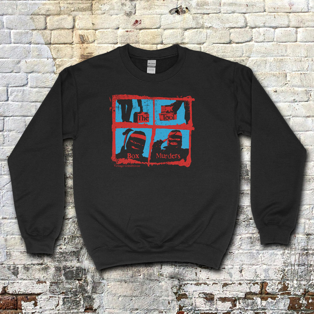 Black sweatshirt featuring red and blue graphic with masked figures and text spelling The Toolbox Murders on front panel