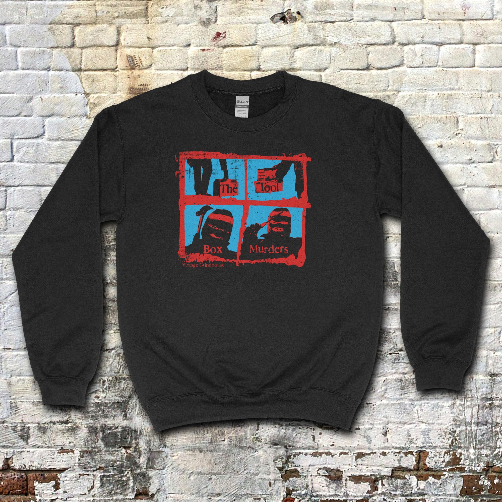 Black sweatshirt featuring red and blue graphic with masked figures and text spelling The Toolbox Murders on front panel