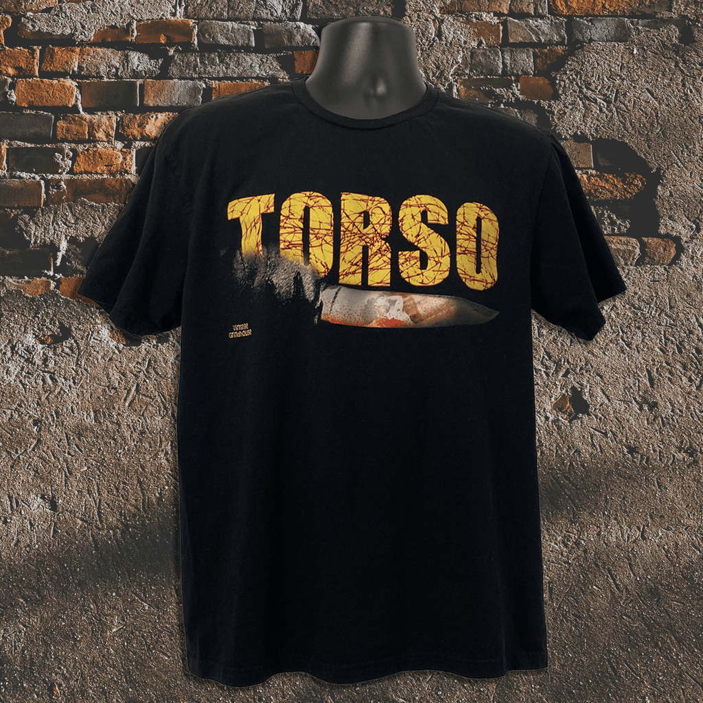 Black t-shirt with 'TORSO' printed in yellow on a textured stone wall background