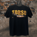 Black t-shirt with 'TORSO' printed in yellow on a textured stone wall background