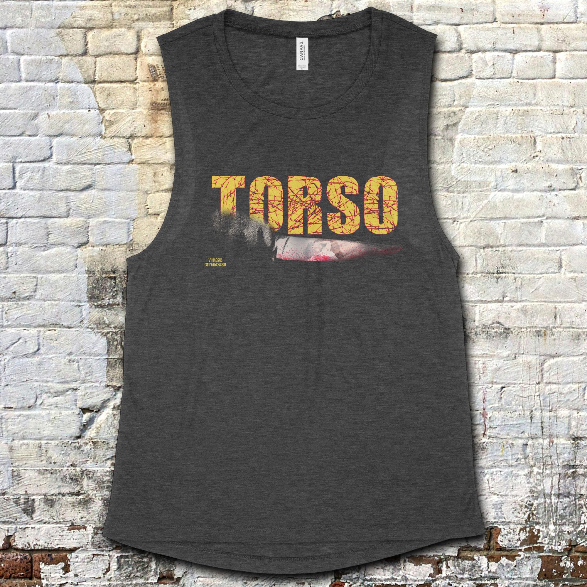 Torso muscle tank featuring bold distressed yellow title with knife graphic on dark gray fabric against brick wall background