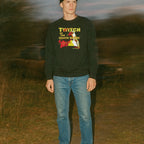 Twitch of the Death Nerve sweatshirt with striking vintage horror print worn outdoors at dusk by standing model