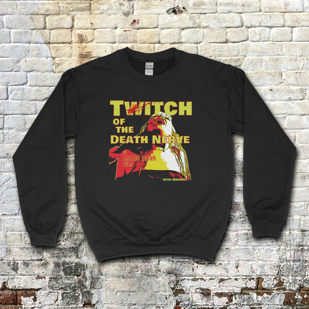 Twitch of the Death Nerve sweatshirt with bold yellow and red horror-themed graphic on black fabric against brick wall background