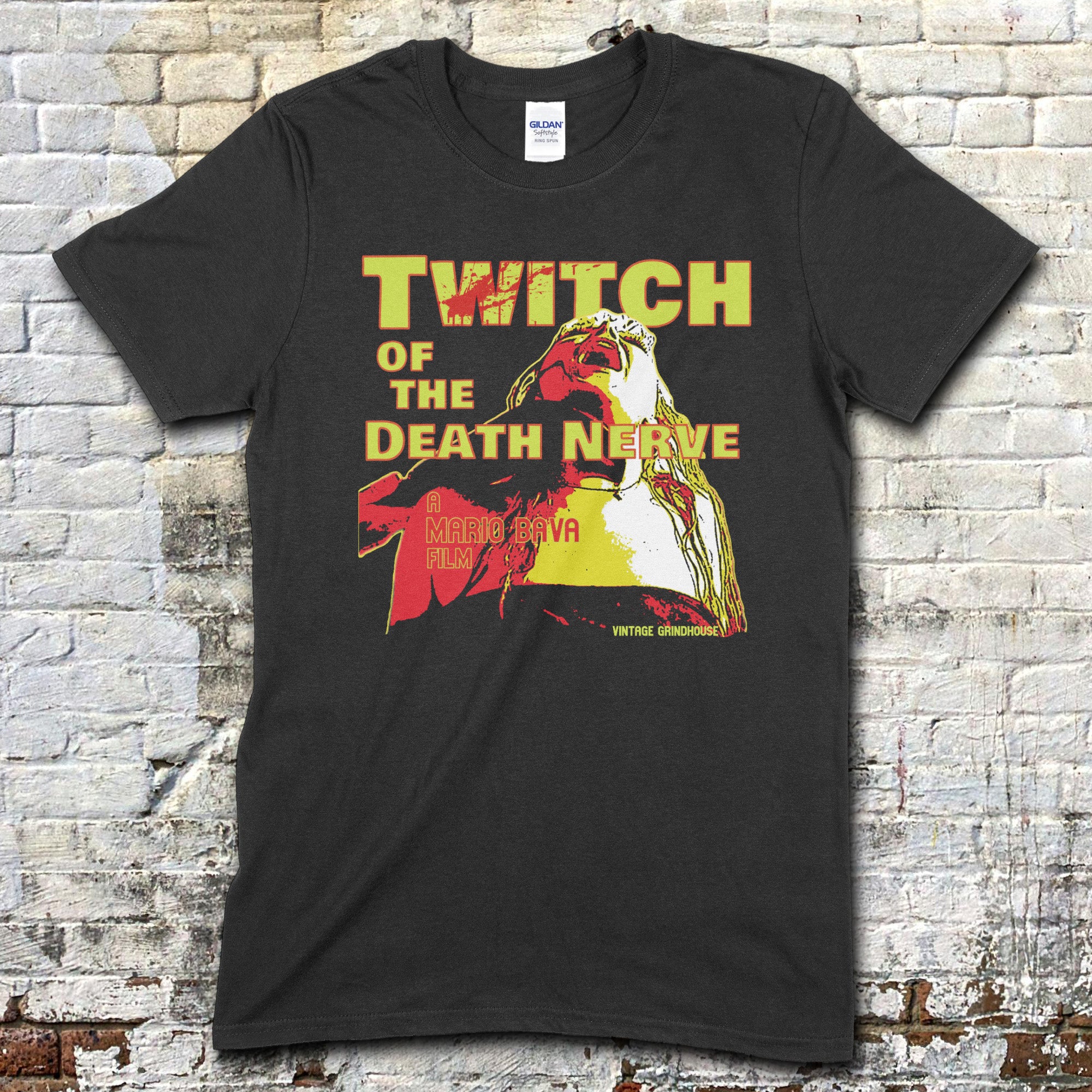 Black t-shirt with Twitch of the Death Nerve graphic design and text on a brick wall background