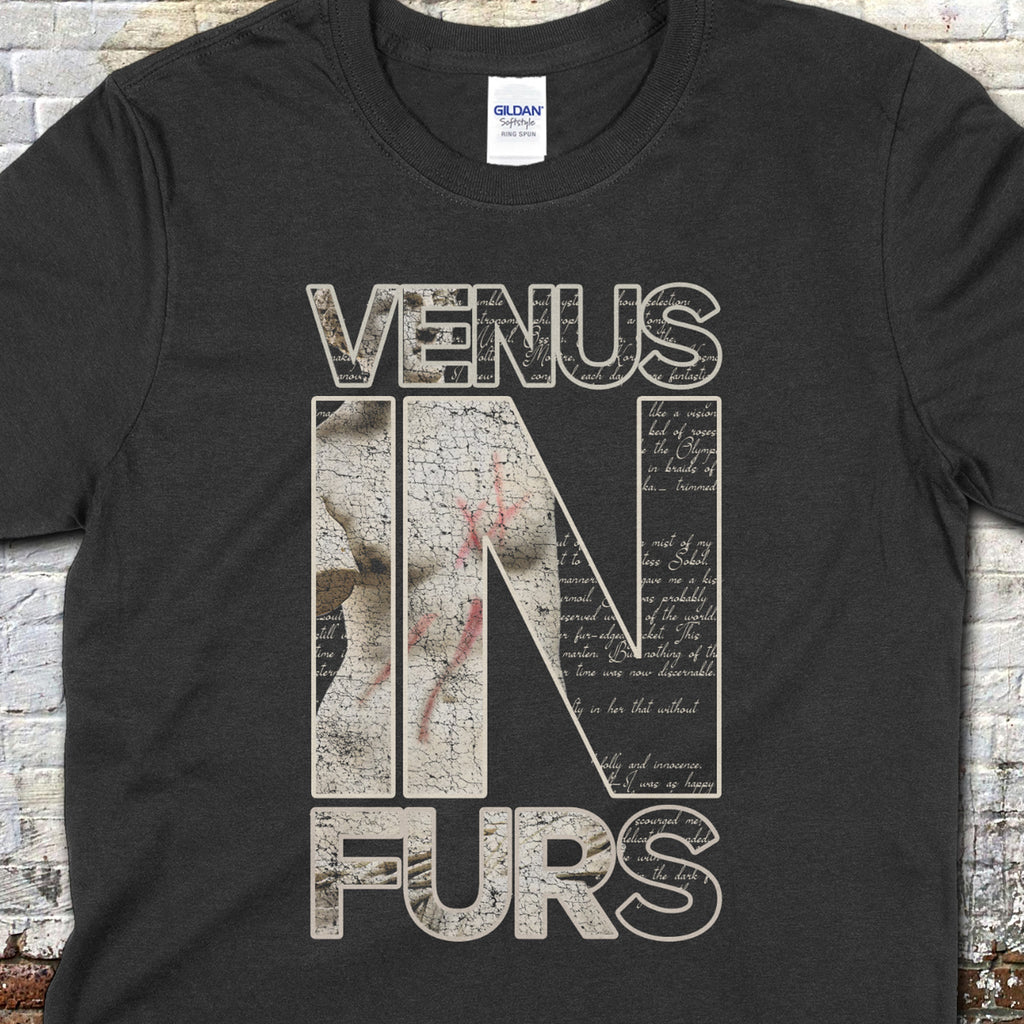 Venus in Furs t-shirt with distressed beige block letters and textured vintage script design on black fabric.