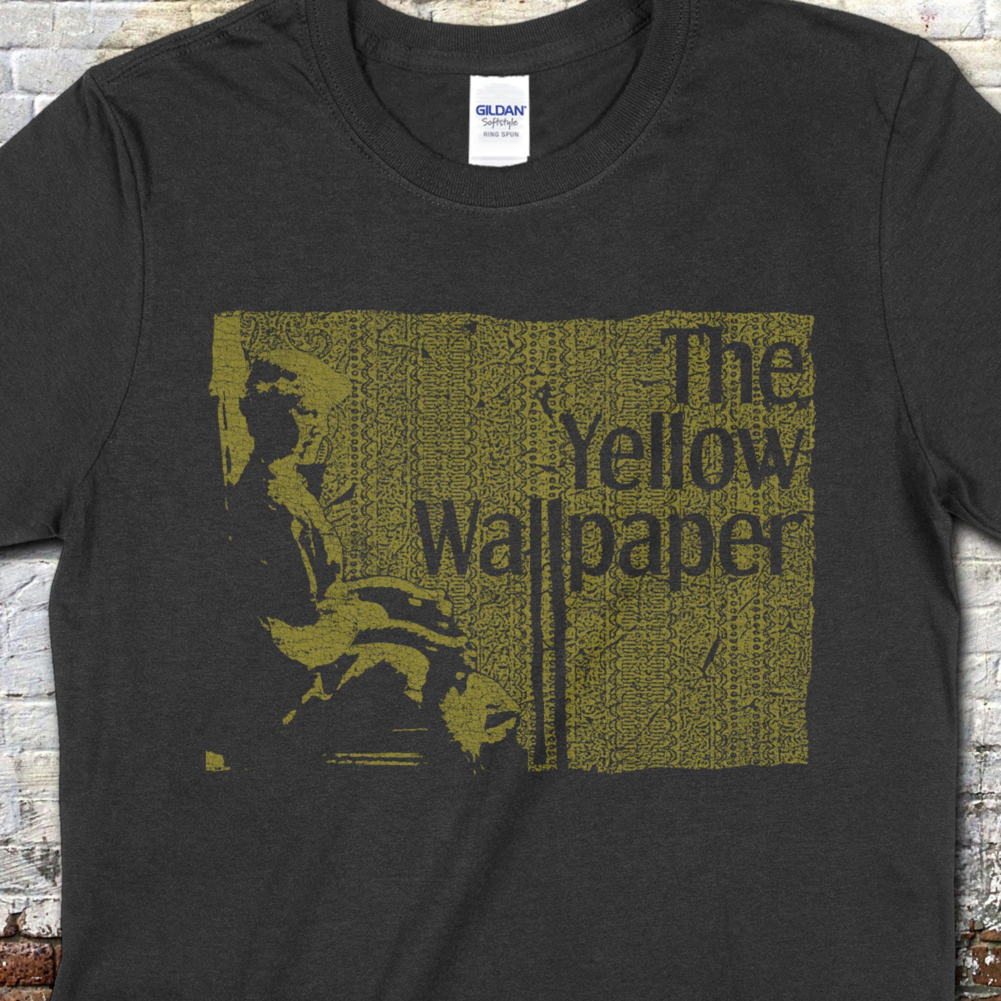 The Yellow Wallpaper t-shirt in dark fabric with vintage yellow textured wallpaper pattern and seated woman silhouette design