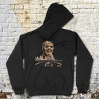 Zombi 2 hoodie with eerie zombie face and city skyline graphic on black fabric laid flat against brick wall background