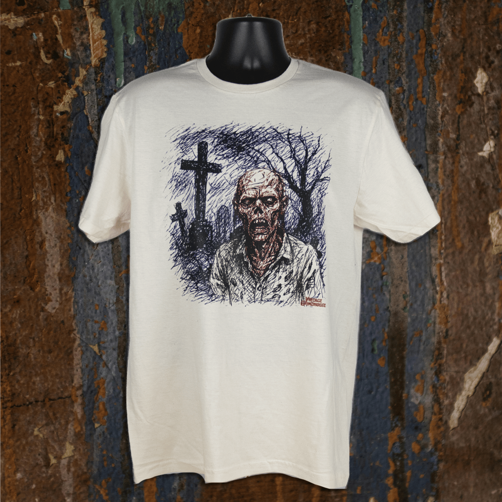 White t-shirt with a graphic design of a zombie and cross on a textured brown background