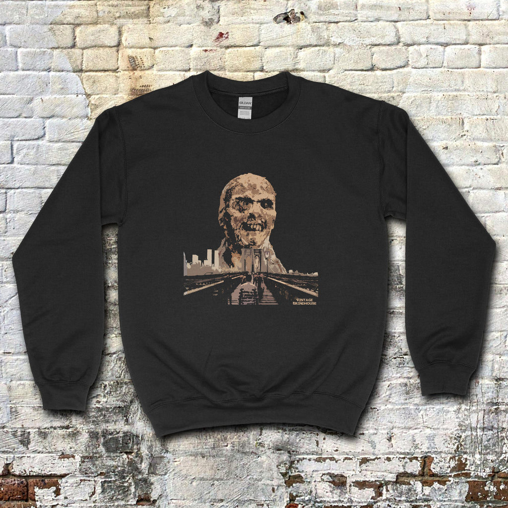 Black Zombi 2 sweatshirt with vintage horror graphic of a decayed zombie head over a cityscape and road